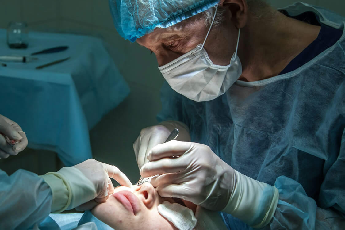 Physician/surgeon performing eye surgery.